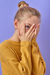 Young caucasian girl wearing casual clothes isolated over purple background covering face with...