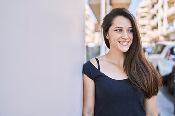 Young hispanic girl smiling happy standing at the city.