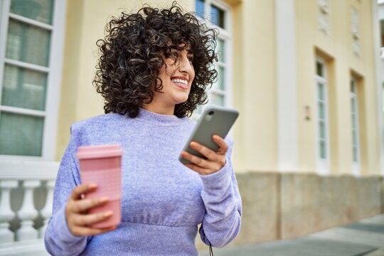 Young middle east woman smiling confident using smartphone at street