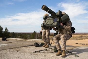 Military rocket , Military training, fighting, fighting, war, shooting big guns , Soldiers game on military training ground ( battle camp ). Action. Operation.