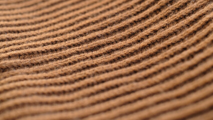 Textile abstract background. Clothing industry concept. Wavy clean material. Fibers of knitted clothes brown white threads. Knitted fabric threads macro