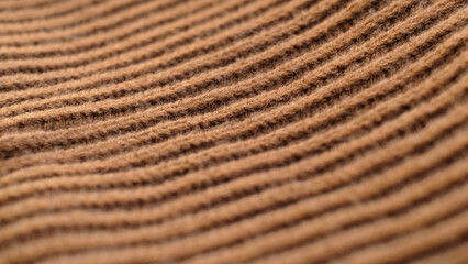 Textile abstract background. Clothing industry concept. Wavy clean material. Fibers of knitted clothes brown white threads. Knitted fabric threads macro