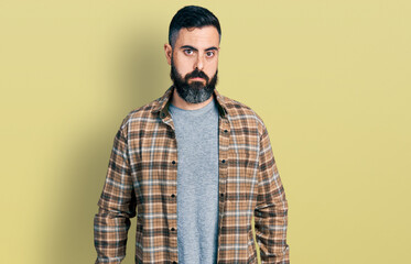 Hispanic man with beard wearing casual shirt depressed and worry for distress, crying angry and...