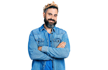 Hispanic man with beard wearing king crown happy face smiling with crossed arms looking at the camera. positive person.