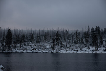 Twilight on a freezing lake in a snowy environment in winter