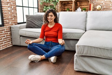 Obraz premium Young latin woman smiling confident doing yoga exercise at home