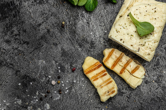 Grilled slices of halloumi cheese with grill marks and mint. Cyprus squeaky cheese. banner, menu, recipe place for text, top view