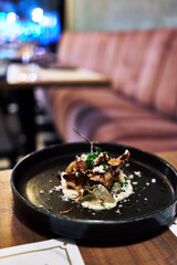  Plate of artichoke and parmesan salad on wooden surface