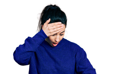 Young hispanic woman wearing casual clothes looking at the watch time worried, afraid of getting...