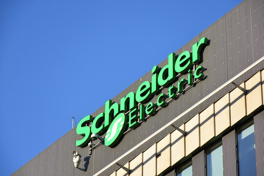 Scheider Electric logo, signage on the facade of Schneider Electric Polska, multinational energy and automation company. WARSAW, POLAND - MAY 11, 2021