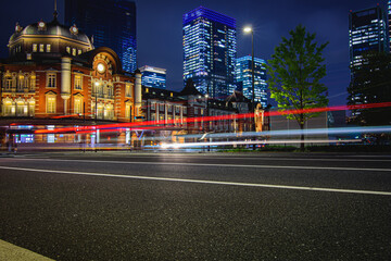 Naklejka premium Night view of the brick-built facade on the western side of Tokyo Station (Marunouchi side) and the office buildings surrounding it.