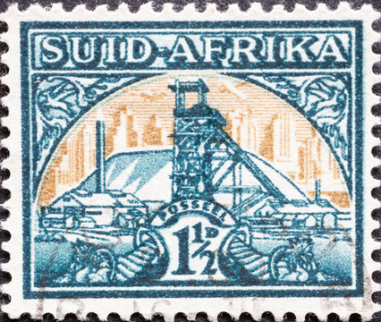 South Africa - Circa 1936: A Postage Stamp From South Africa, Showing Mining Facilities And The Headframe Of A Gold Mine