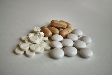 medicine capsules and pills different colours isolated white