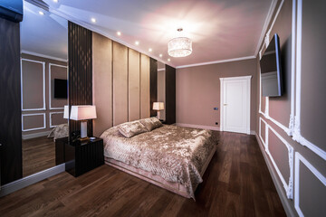 Large double bed in the bedroom. The room has been renovated in Baroque style in brown and beige...