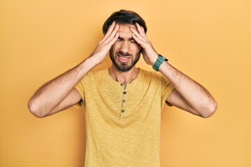 Young hispanic man wearing casual clothes suffering from headache desperate and stressed because pain and migraine. hands on head.