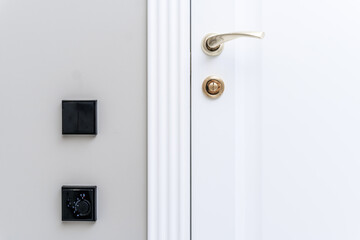 Stylish bronze door handle and lock on a white new interior door
