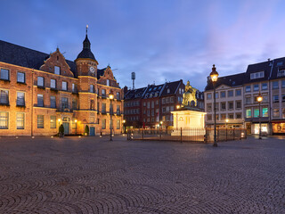 Town hall in the old town of Dusseldorf in Germany. Beautifully illuminated Central Square with the Johann Wilhelm II monument at the blue hour before dawn.