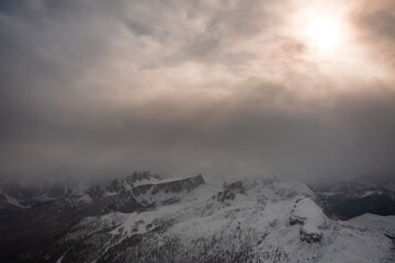 Fototapeta na wymiar Stormy clouds in italian dolomites in a snowy winter