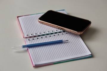 pen, notebook, phone on white office table