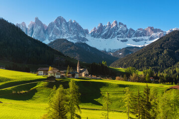 Sunny spring landscape of Dolomites Alps. Famous Santa Maddalena village with church and beautiful Dolomiti mountains