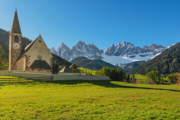 Santa Maddalena village with church and beautiful Dolomiti mountains, Val Di Funes, Dolomites, Italy in sunny morning