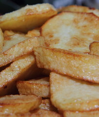 Fried potato. Culinary dish. Cooking process. Deep-fried cooking.