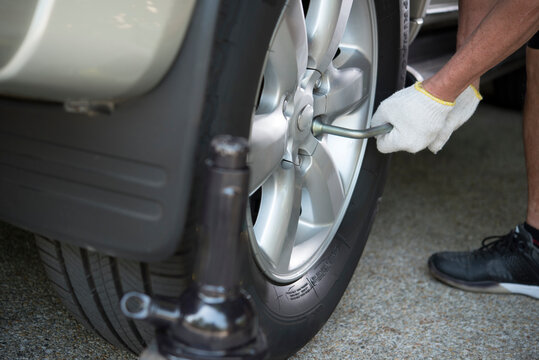 hands in glove doing vehicle tyre alignment