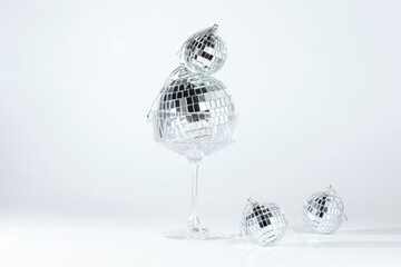 Composition of disco balls in glass on white background