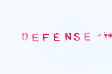 Red color ink rubber stamp in word defense on white paper background