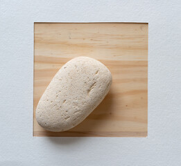 stone and paper frame on wooden table 