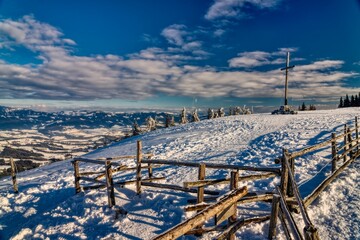 landscape in the mountains with peak cross