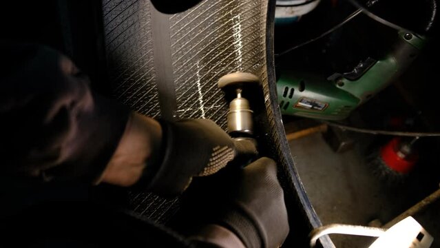 Repair service for wheel tire of car from small puncture, skive the tire before glue for plaster with drilling machine.