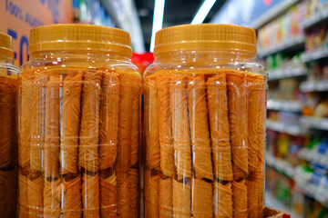 Love letters, traditional Peranakan snacks in plastic jars sold in supermarket. These sweet crispy...