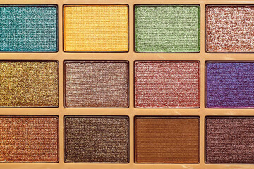 A palette of shimmery eyeshadows in different colors.