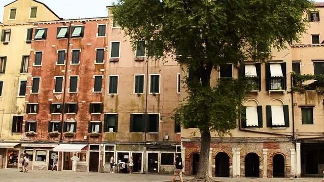 Venice, Veneto Region, Italy. August 2018. Campo del Ghetto Nuovo, Jewish Quarter. The charm of the old houses of this square. Filmed with quick overview on the square.