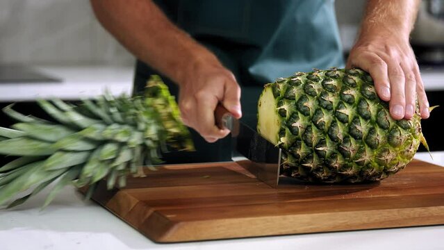 chef cuts the pineapple slow motion, chief make pineapple ,  slice the pineapple  close-up