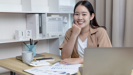 Asian woman checks company financial documents in her home office, Use a tablet to work, Working at home, Home lifestyle, Stay home, New normal, Social distancing.