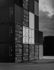 Fototapeta premium stacked up cargo containers at night