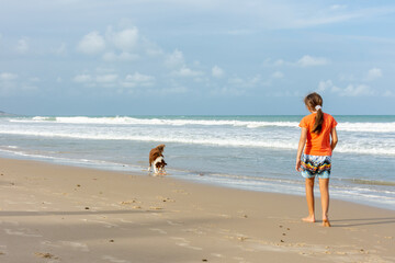Cachorro com crian&ccedil;a  na praia