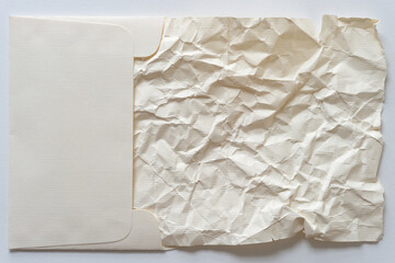 old paper sheet crumpled set sideways in a laid paper envelope