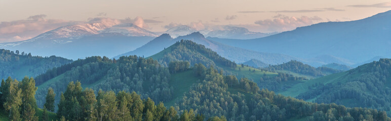 Evening haze in the mountains. Spring landscape. Panoramic view.