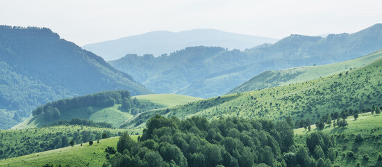 Evening haze in the mountains. Spring landscape. Panoramic view.