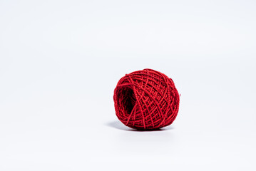 Fototapeta premium Medium size bright red ball of yarn on white background