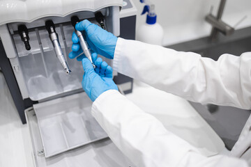 Close up view of dentist using dental handpiece cleaning and lubricating machine