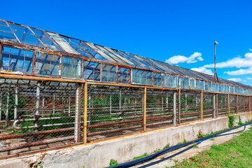 Old greenhouse exterior view . Hothouse construction