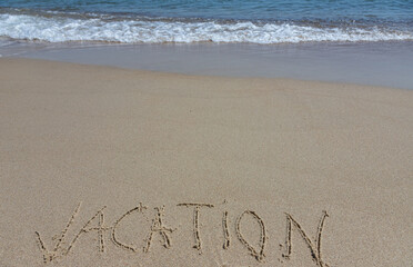 Handwritting inscription Vacation word on tropical sandy beach, travel concept card for holidays