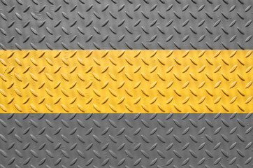 grey with yellow stripe painted industrial steel sheeting with grid textured flooring pattern