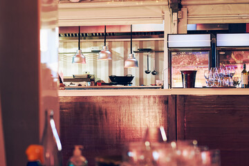 view of the modern restaurant kitchen bar from the diners' table