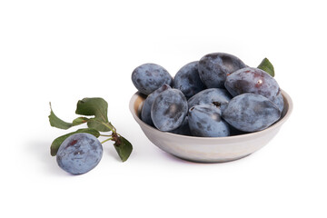 saucer with ripe unwashed plums. Sprig with plum and leaf