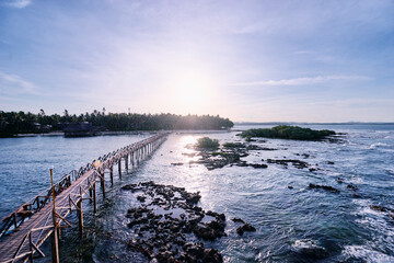 Beautiful landscape. Sunset on the seashore. Wooden bridge on Cloud 9 beach, Siargao Island Philippines.
